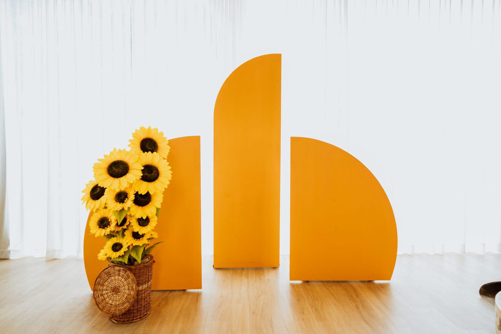 Orange arc backdrop with sunflowers at Veedo Lumen studio