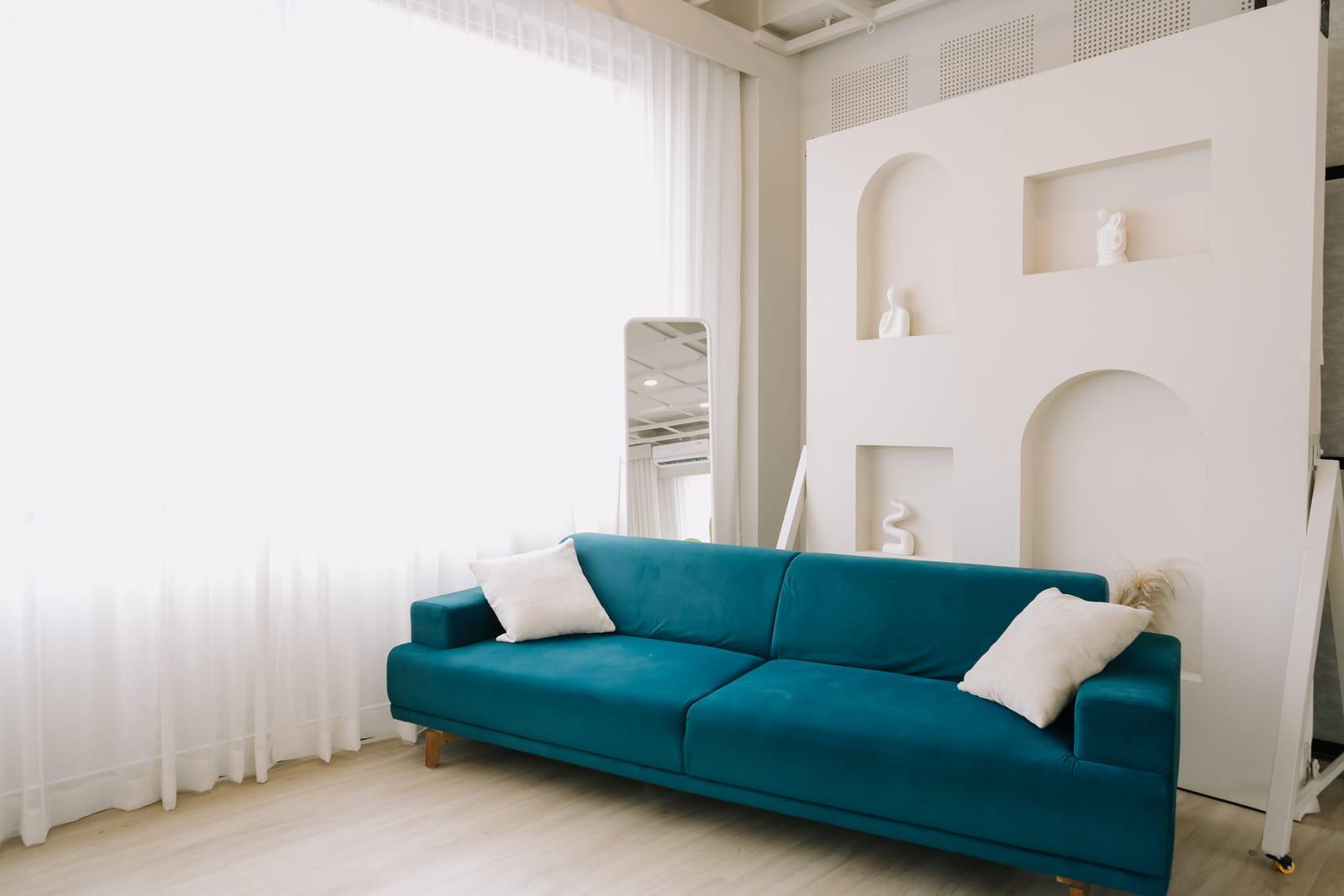 Teal sofa editorial setup at Veedo Lumen studio Kochi